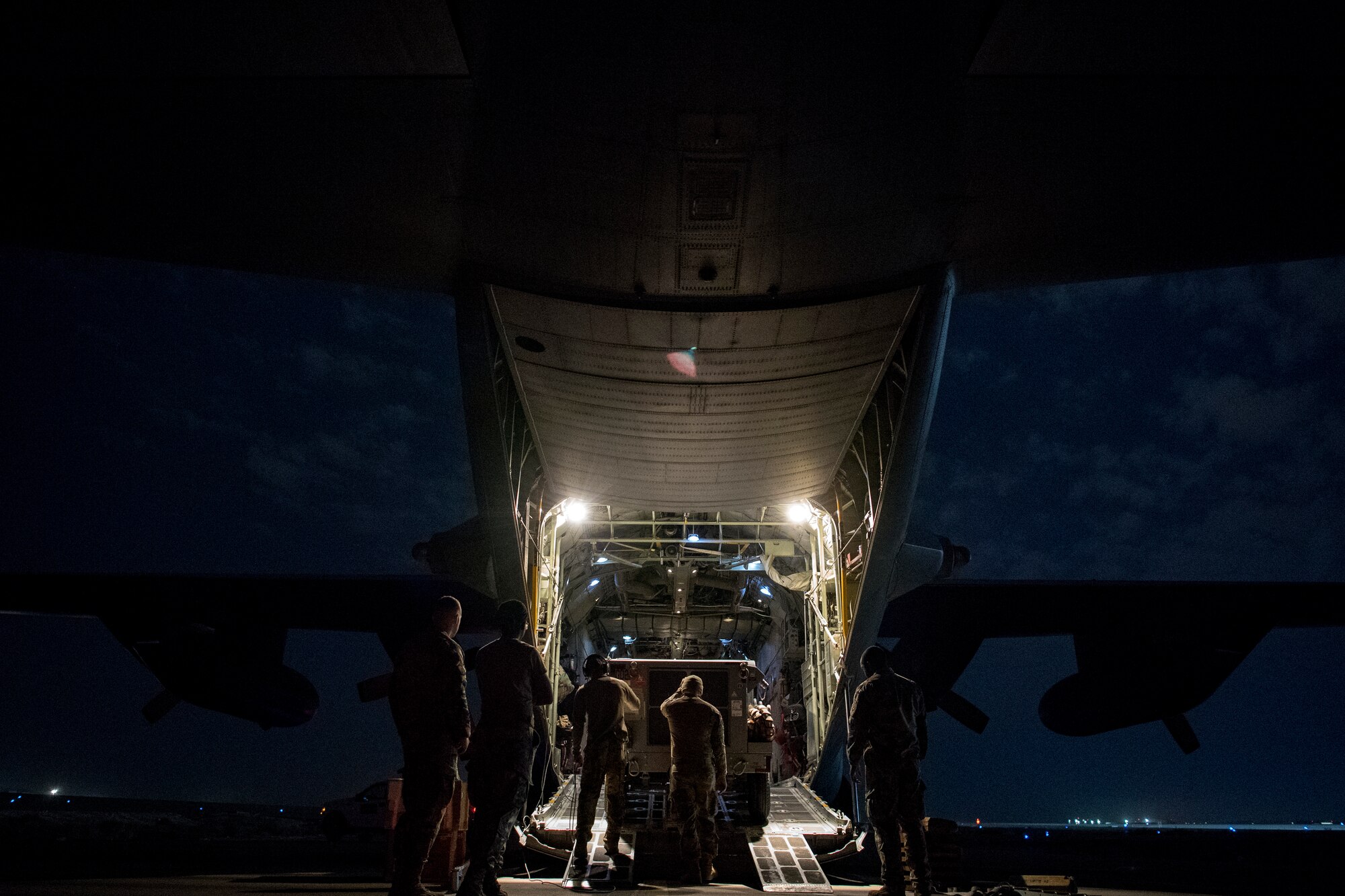 U.S. Air Force aerial porters assigned to U.S. Air Forces Central Command load cargo into a C-130 Hercules in the U.S. Central Command area of responsibility, Jan. 8, 2020.
