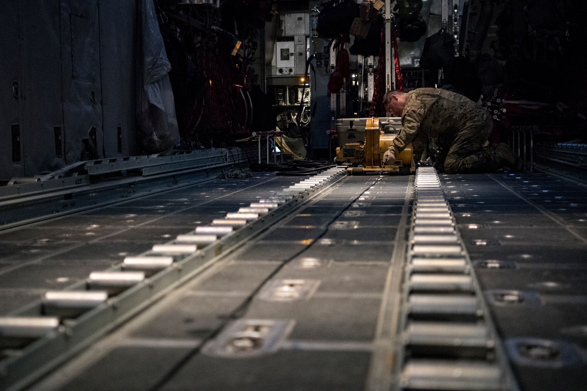 A U.S. Air Force loadmaster assigned to to the 746th Expeditionary Airlift Squadron prepares to load cargo into a C-130 Hercules in the U.S. Central Command area of responsibility, Jan. 8, 2020.