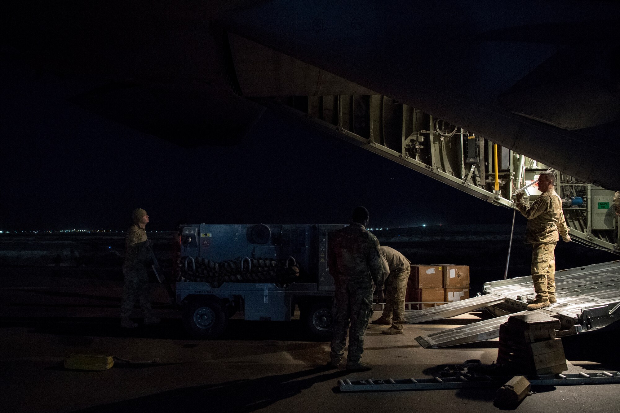U.S. Air Force aerial porters assigned to U.S. Air Forces Central Command load cargo into a C-130 Hercules in the U.S. Central Command area of responsibility, Jan. 8, 2020.