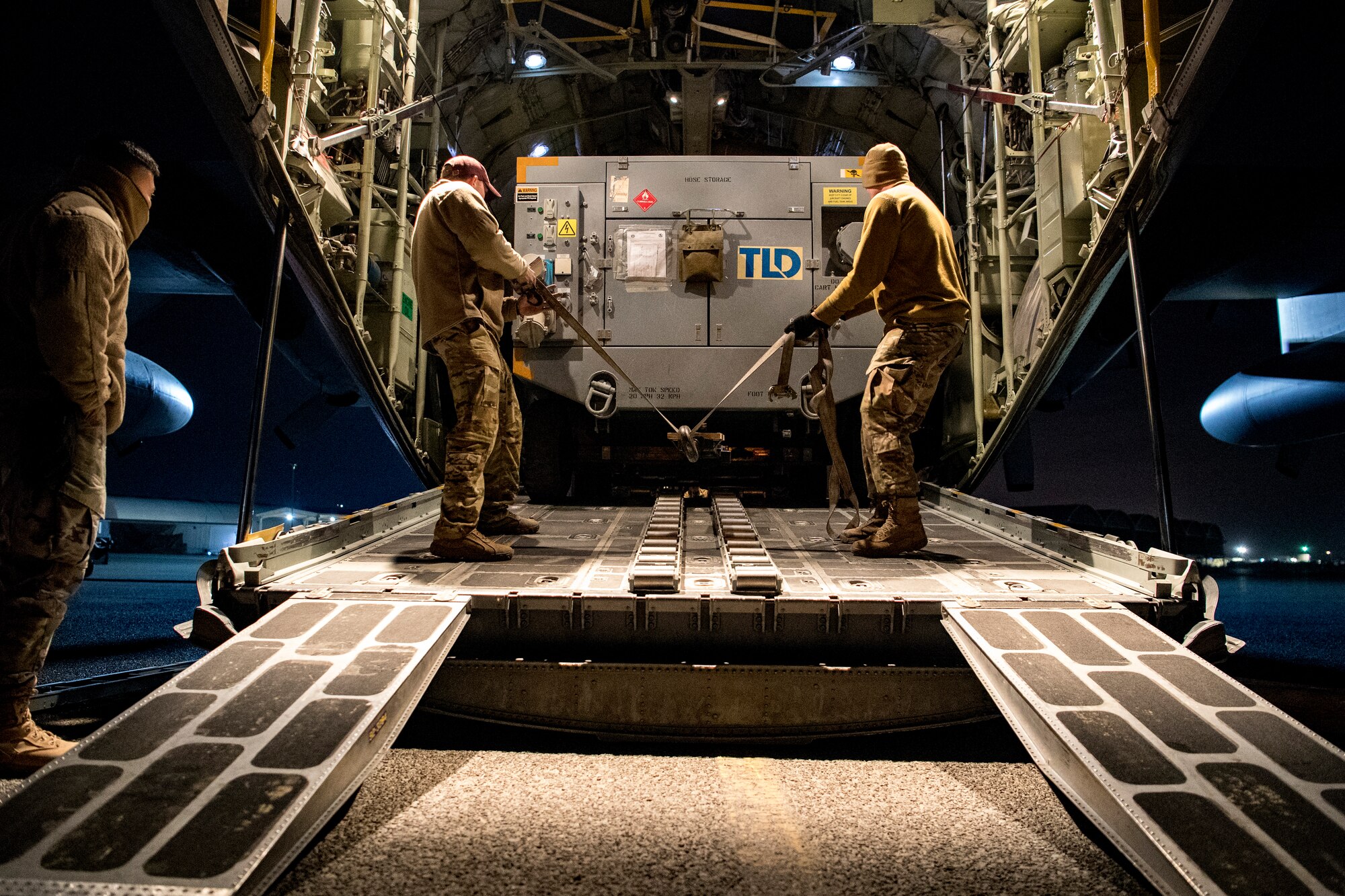 U.S. Air Force aerial porters assigned to U.S. Air Forces Central Command unload cargo from inside a C-130 Hercules in the U.S. Central Command area of responsibility, Jan. 8, 2020.