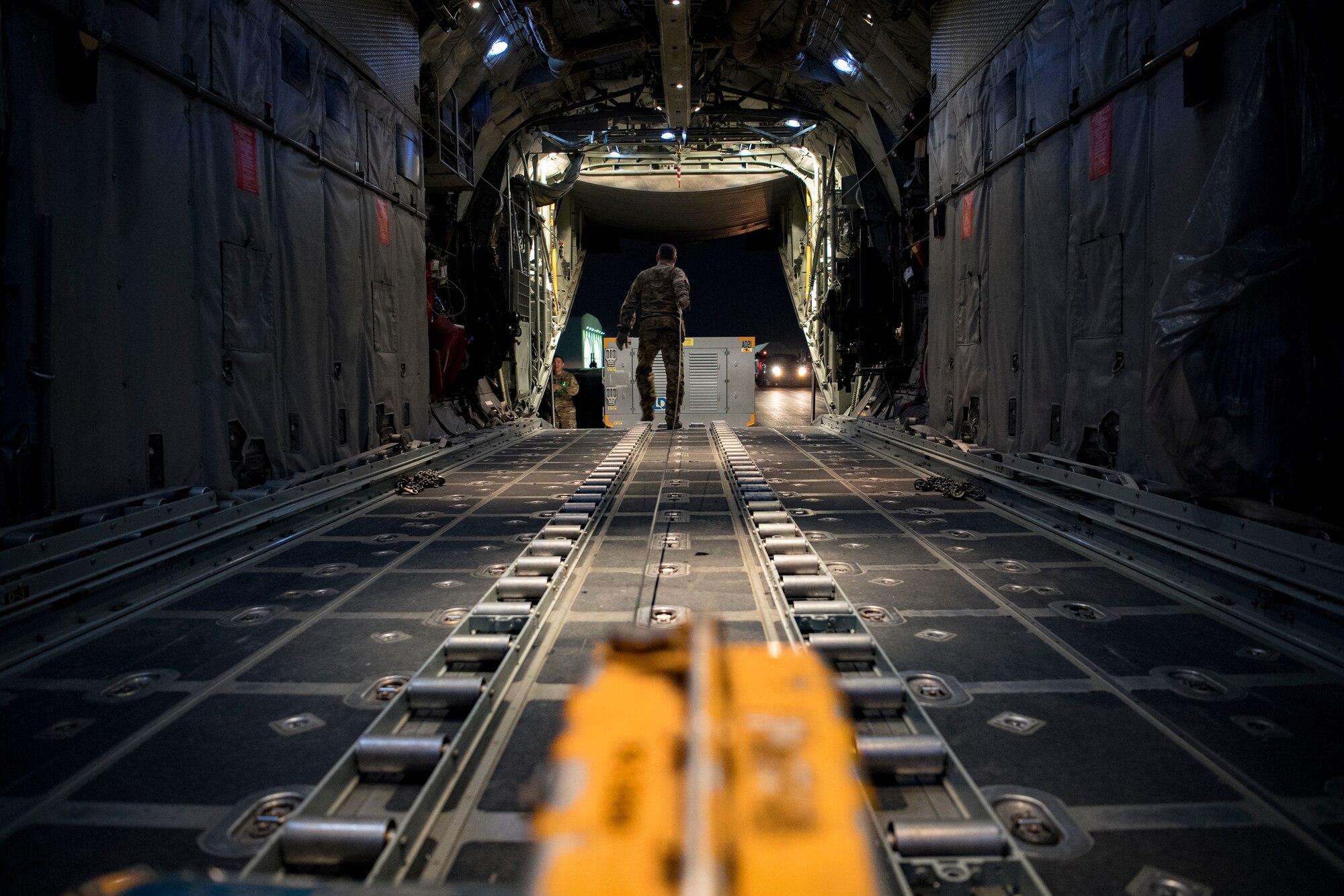 A U.S. Air Force loadmaster assigned to the 746th Expeditionary Airlift Squadron prepares to load cargo into a C-130 Hercules in the U.S. Central Command area of responsibility, Jan. 8, 2020.