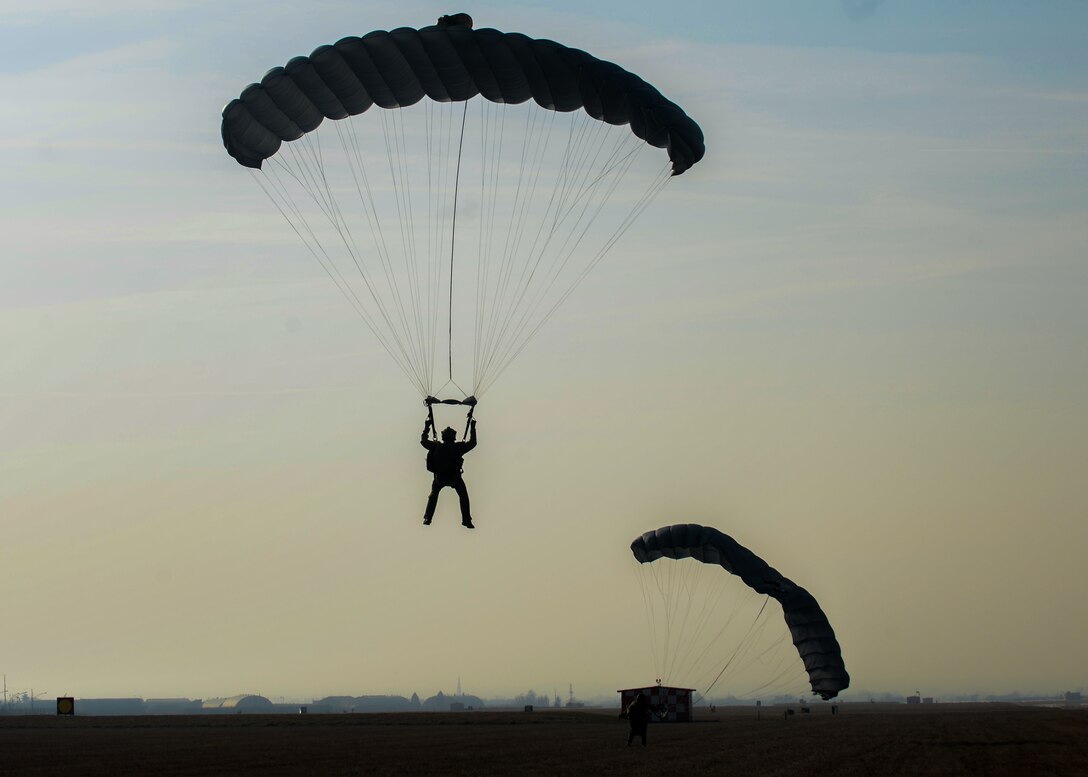 A U.S. Air Force Airman from the 57th Rescue Squadron parachutes toward the airfield at Aviano Air Base, Italy, Jan. 15, 2020. Pararescue specialists are skilled parachutists, scuba divers and rock climbers, and are also arctic-trained so they can access any environment in order to save a life. (U.S. Air Force photo by Airman Thomas S. Keisler IV)