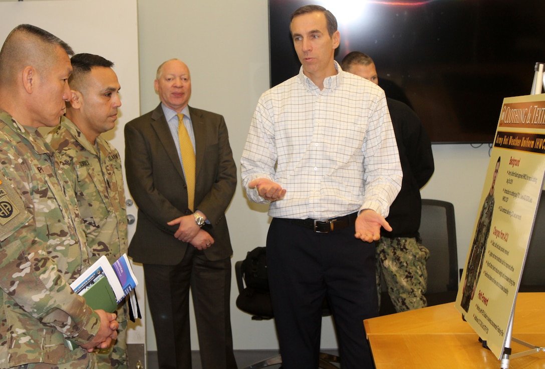 Army Sgt. Majs. Fu Pi, far left, and Marco Torres, second from left, listen as DLA Troop Support Clothing and Textiles Director of Supplier Operations Steve Merch provides information on C&T’s ongoing efforts in support of Army uniforms Jan. 10, 2020, in Philadelphia.