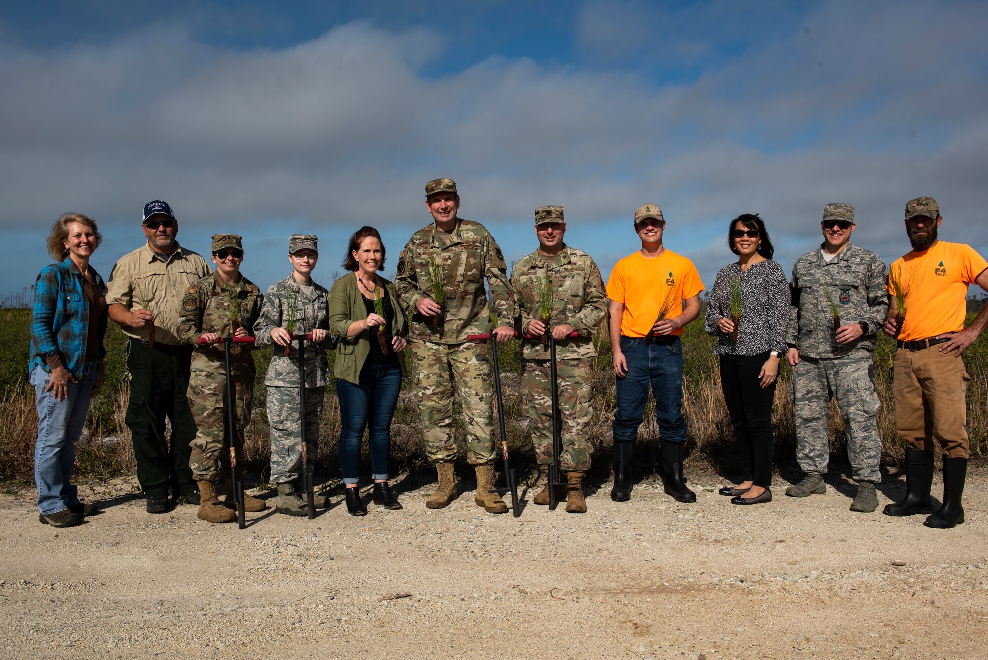 U.S. Air Force Col. Gregory Beaulieu, 325th Mission Support Group commander, center, poses for a group photo at Tyndall Air Force Base, Florida, Jan. 15, 2020. The group members held  longleaf pine trees which will be planted through a  partnership between U.S. Air Force service members, Department of Defense contracted employees, and representatives of the U.S. Fish and Wildlife Service. (U.S. Air Force photo by Staff Sgt. Magen M. Reeves)