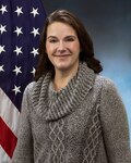 lady in front of an American flag and blue background