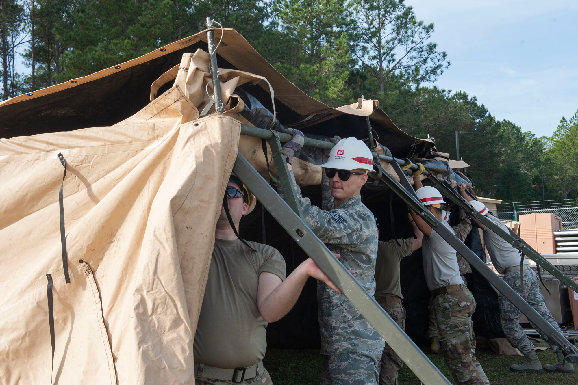 Photo of Airmen putting up a tent