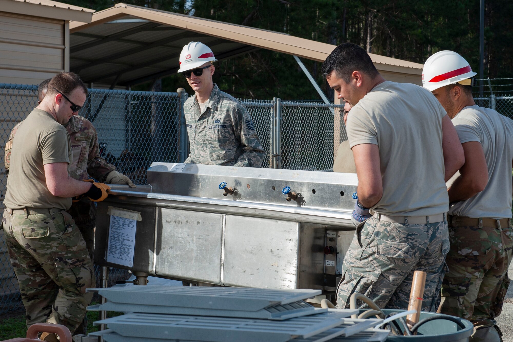 Photo of Airmen carrying a sink