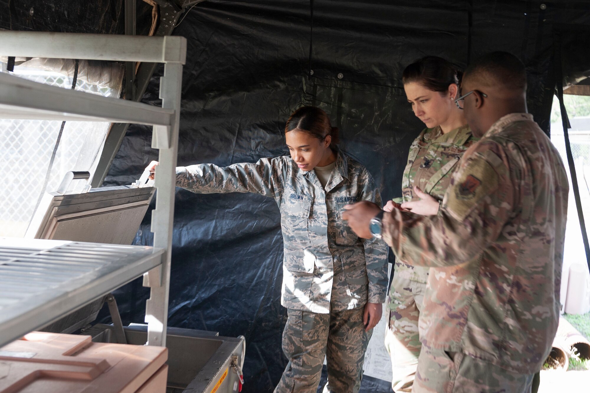 Photo of Airmen looking into a meal heating unit
