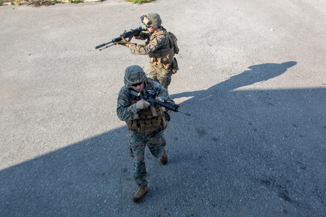 U.S. Marines with the Special Purpose Marine Air-Ground Task Force-Crisis Response-Africa 20.1, Marine Forces Europe and Africa, maneuver to the next checkpoint during a military operations in urban terrain training event at Naval Station Rota, Spain, Jan. 9, 2020. The purpose of MOUT is to maintain mission readiness while providing scenarios that allow Marines and Sailors to practice their combat capabilities. SPMAGTF-CR-AF is deployed to conduct crisis-response and theater-security operations in Africa and promote regional stability by conducting military-to-military training exercises throughout Europe and Africa. (U.S. Marine Corps photo by Cpl. Kenny Gomez)