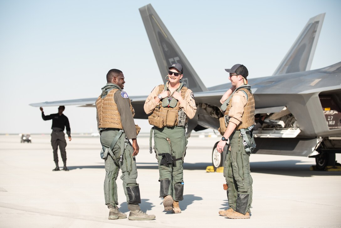 U.S. Air Force Lt. Col. Paul Lopez, F-22 Raptor Demonstration Team commander, debriefs with Capt. Kenan Bell and Capt. William McCarthy, F-22 pilots, after landing at the Dubai Air Show, United Arab Emirates, Nov. 14, 2019.