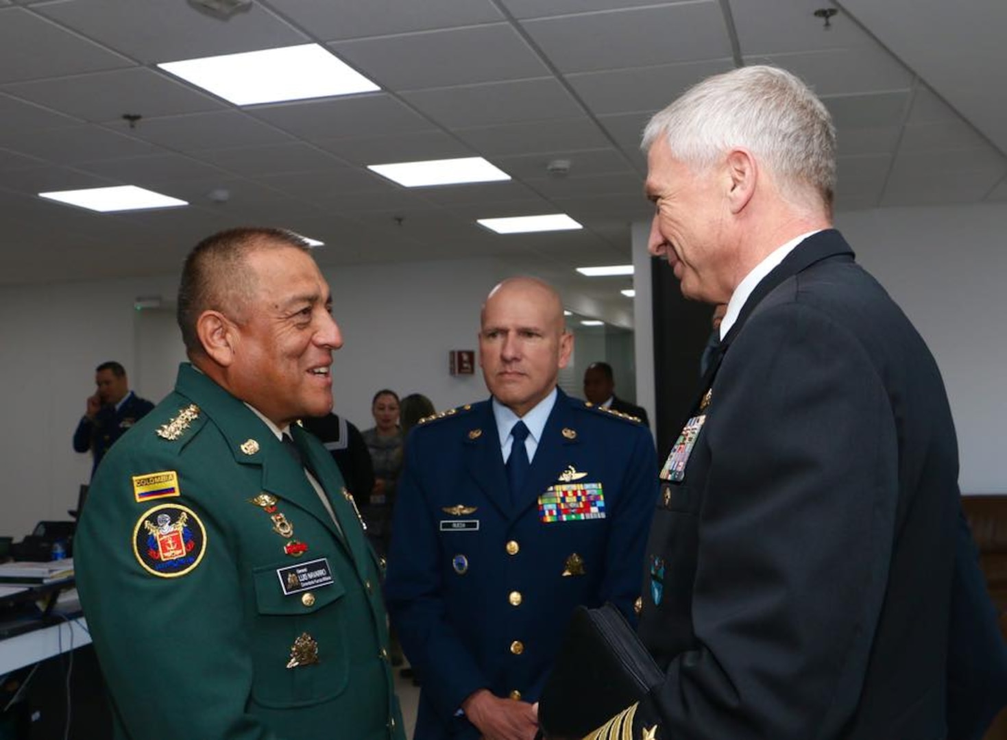 Colombian Chief of Defense Maj. Gen. Luis Navarro and U.S. Navy Adm. Craig S. Faller greet each other.