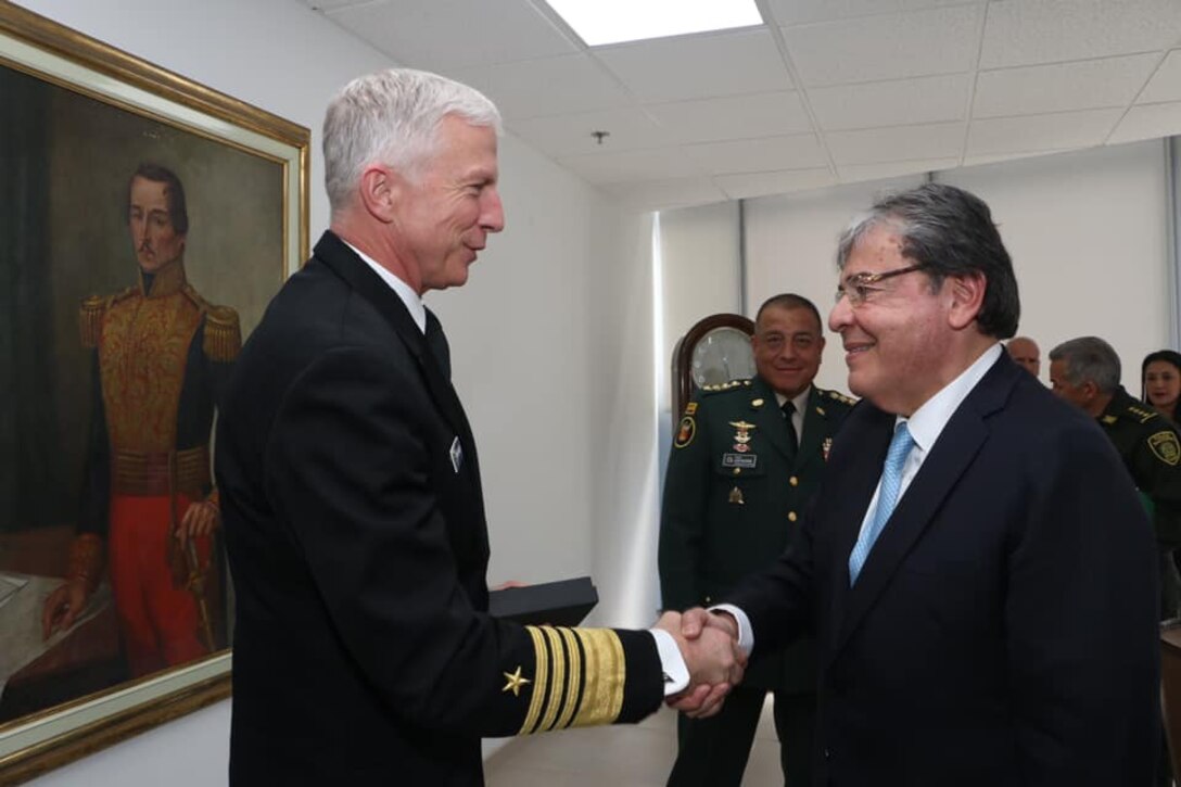 Colombian Minister of Defense Carlos Holmes Trujillo greets U.S. Navy Adm. Craig S. Faller.