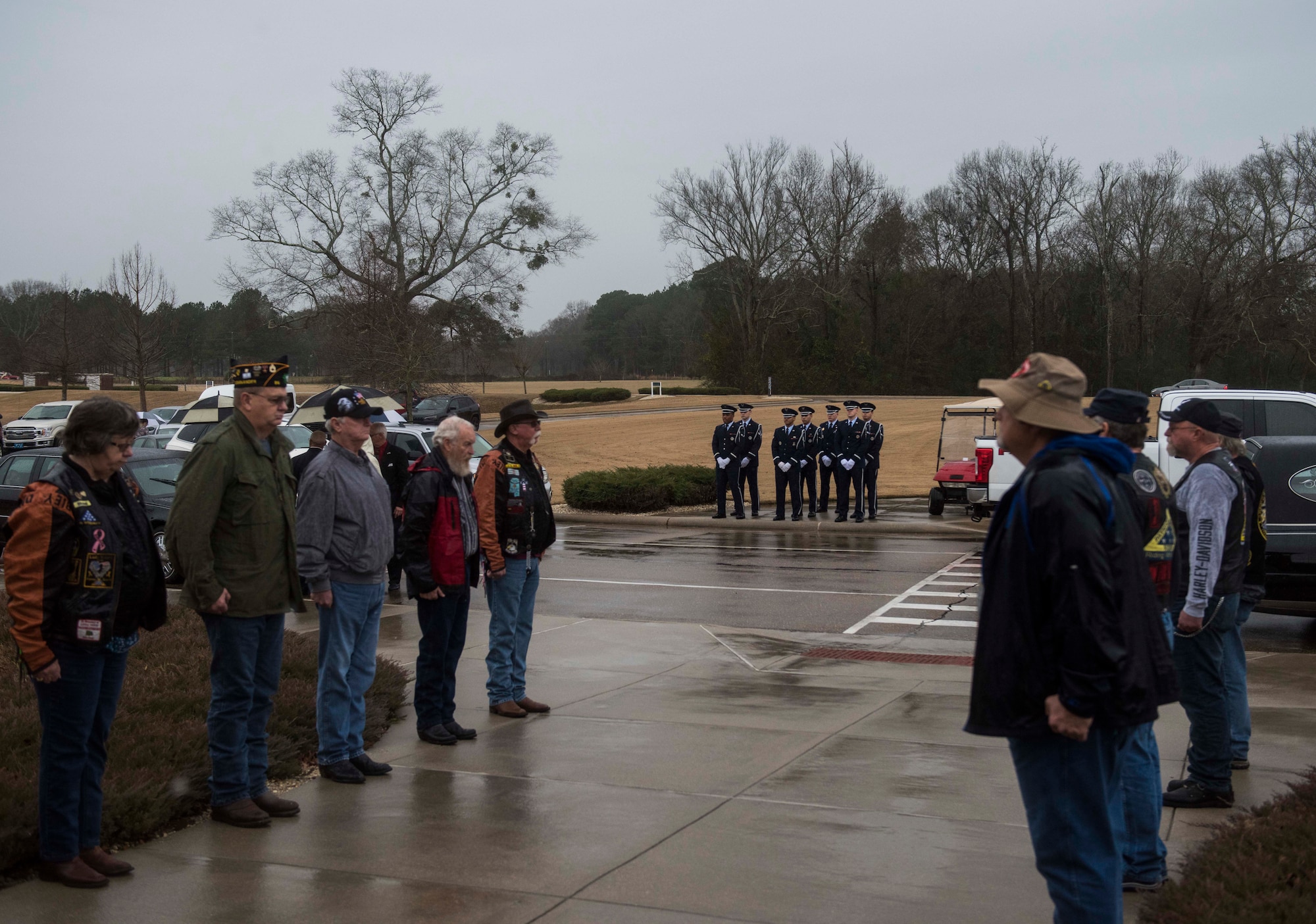Prior military service members stand at attention while Columbus Air Force Base Honor Guardsmen stand at parade rest at the Mississippi Veterans Memorial Cemetery on Jan. 13, 2020, in Newton County, Miss. The honor guardsmen were preparing to unload the casket of Staff Sgt. Tharin McNichols, a member of the 855th Aircraft Maintenance Squadron at Nellis Air Force Base, Nev. (U.S. Air Force photo by Airman Davis Donaldson)