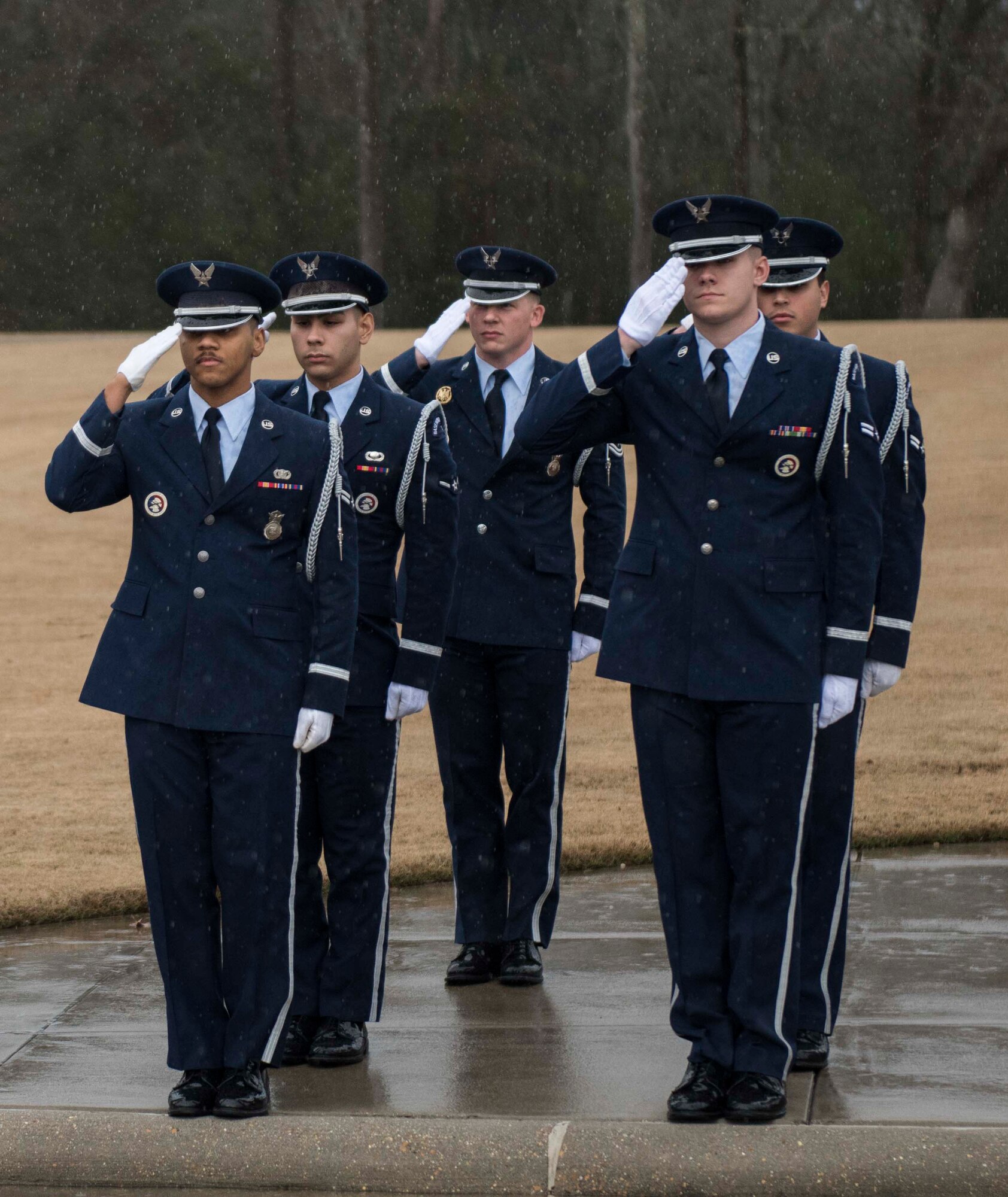 Columbus Air Force Base Honor Guardsmen salute as a hearse carrying the body of Staff Sgt. Tharin McNichols passes at the Mississippi Veterans Memorial Cemetery on Jan. 13, 2020, in Newton County, Miss. McNichols was a member of the 855th Aircraft Maintenance Squadron at Nellis Air Force Base, Nev. The honor guard’s primary mission is to provide military honors to fallen service members, but they also perform at official Air Force ceremonies and parades. (U.S. Air Force photo by Airman Davis Donaldson)