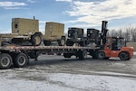 A DLA Disposition Services forklift driver prepares diesel generators for transport to the Bahamas.