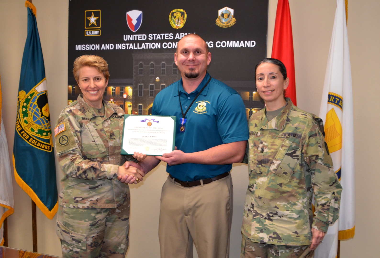Brig. Gen. Christine Beeler (left) presents the Civilian Service Achievement Medal to Tyler Kurth recently as Command Sgt. Maj. Chantel Sena-Diaz looks on during a ceremony at Joint Base San Antonio-Fort Sam Houston.