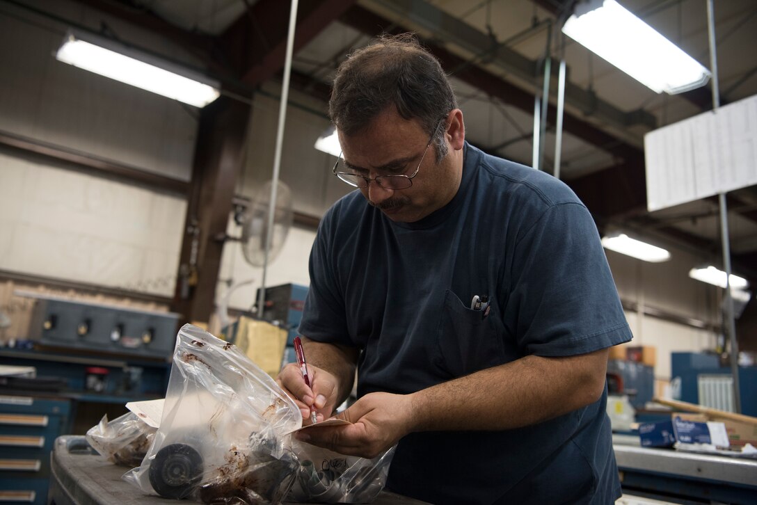 Luis Kalinchuk, a 47th Maintenance Directorate machinist, tags bagged couplings for their transfer to the cleaning section on Jan. 14, 2020 at Laughlin Air Force Base, Texas. 47th MXD machinists use specialized cutting and shaping tools to fabricate replacement pieces for any number of aircraft and aircrew ground equipment. (U.S. Air Force photo by Senior Airman John A. Crawford)