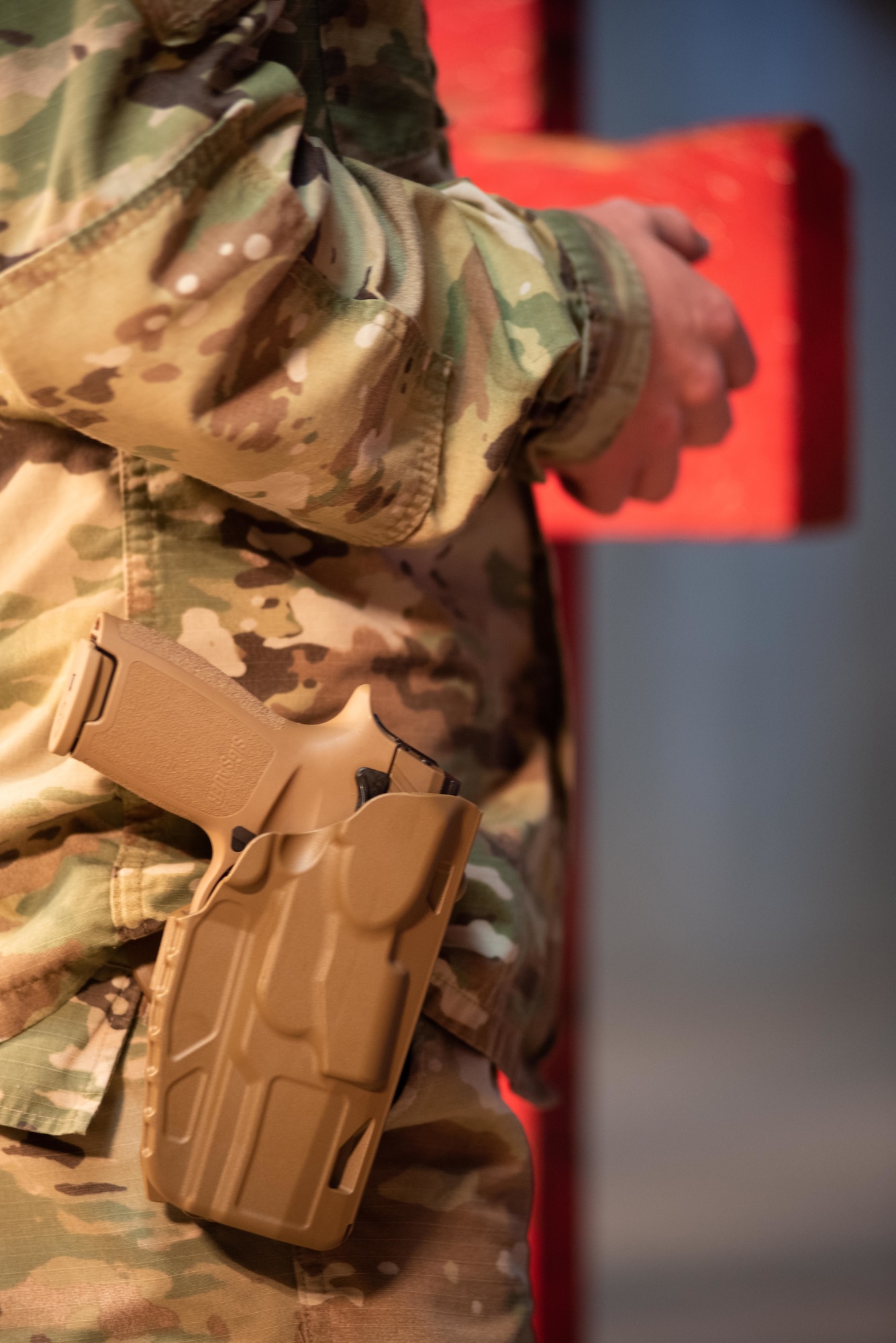 A 22nd Security Forces Squadron combat arms training and maintenance instructor aims an M18 pistol down range Jan. 10, 2019, at McConnell Air Force Base, Kansas. The handgun has many features, from the glowing sights to the lightweight frame, making it a practical and efficient weapon. (U.S. Air Force photo by Staff Sgt. Chris Thornbury)