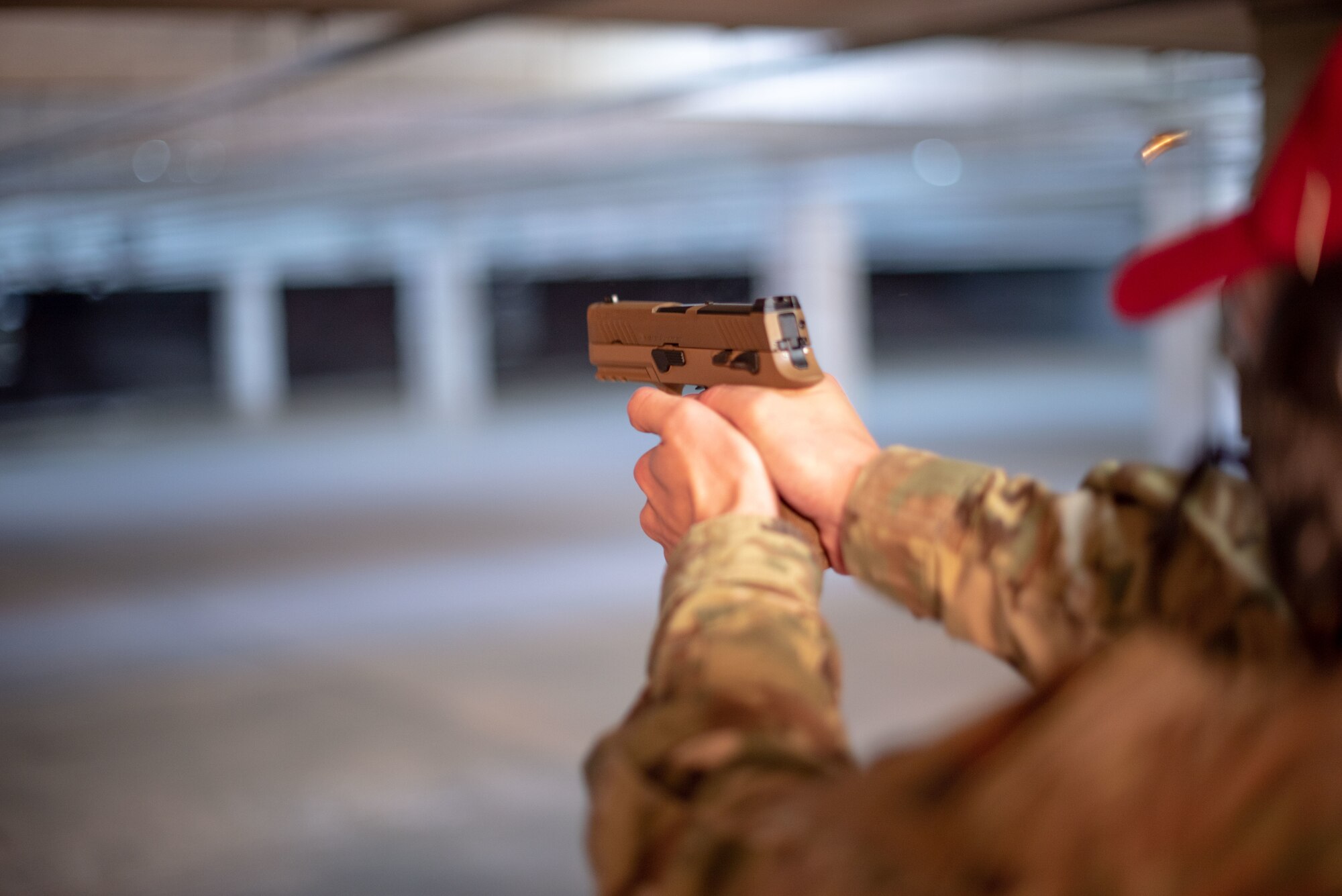 Tech. Sgt. Matt Leake, 22nd Security Forces Squadron combat arms and maintenance instructor, fires an M18 pistol Jan. 10, 2019, at McConnell Air Force Base, Kansas. Defenders are adopting the handgun to enhance base security with modern firearm technology. (U.S. Air Force photo by Staff Sgt. Chris Thornbury)
