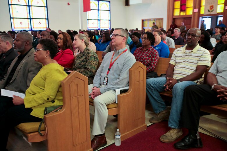 A standing-room-only crowd gathered in the Base Chapel aboard Marine Corps Logistics Base Albany for the annual Dr. Martin Luther King Jr., observance ceremony, Jan. 16.  Individuals listened intently, with varying looks of dismay, pain, shock and disbelief on their faces, as Dr. Shirley Green-Reese, one of the original Leesburg Stockade Girls, shared her story. (U.S. Marine Corps photo by Jennifer Parks)