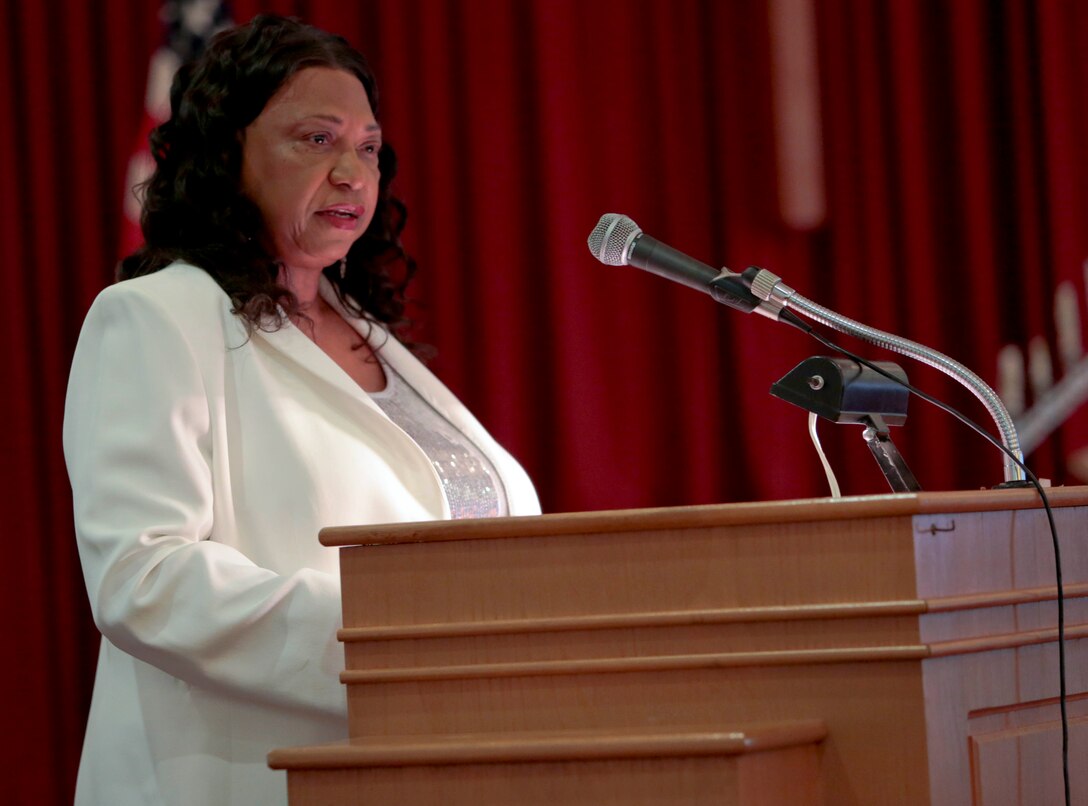 A standing-room-only crowd gathered in the Base Chapel aboard Marine Corps Logistics Base Albany for the annual Dr. Martin Luther King Jr., observance ceremony, Jan. 16.  Individuals listened intently, with varying looks of dismay, pain, shock and disbelief on their faces, as Dr. Shirley Green-Reese, one of the original Leesburg Stockade Girls, shared her story. (U.S. Marine Corps photo by Jennifer Parks)