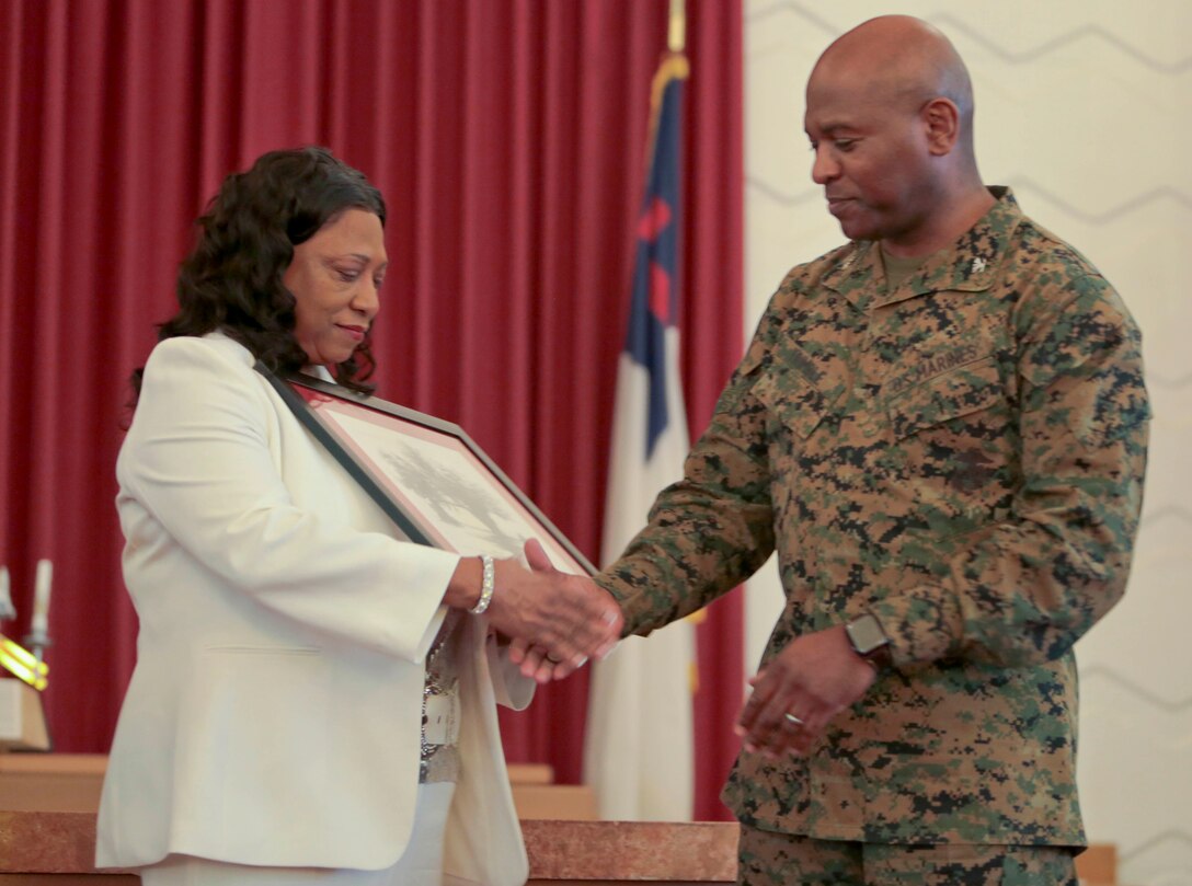 A standing-room-only crowd gathered in the Base Chapel aboard Marine Corps Logistics Base Albany for the annual Dr. Martin Luther King Jr., observance ceremony, Jan. 16.  Individuals listened intently, with varying looks of dismay, pain, shock and disbelief on their faces, as Dr. Shirley Green-Reese, one of the original Leesburg Stockade Girls, shared her story. (U.S. Marine Corps photo by Jennifer Parks)