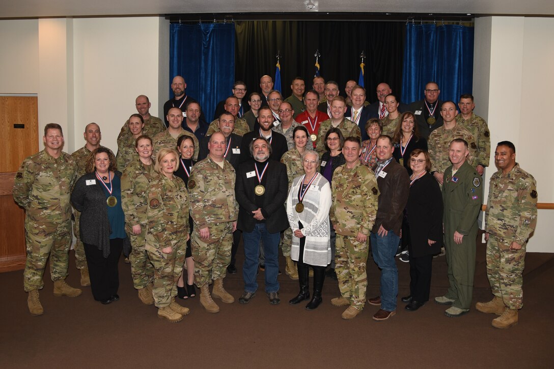 90th Missile Wing commanders and honorary commanders pose for a group photo during an induction ceremony Jan. 13 in the Trails End on F. E. Warren Air Force Base, Wyo. The honorary commander program is intended to build and strengthen bridges in the local community through individual relationships with civic leaders. (U.S. Air Force photo by Glenn S. Robertson)
