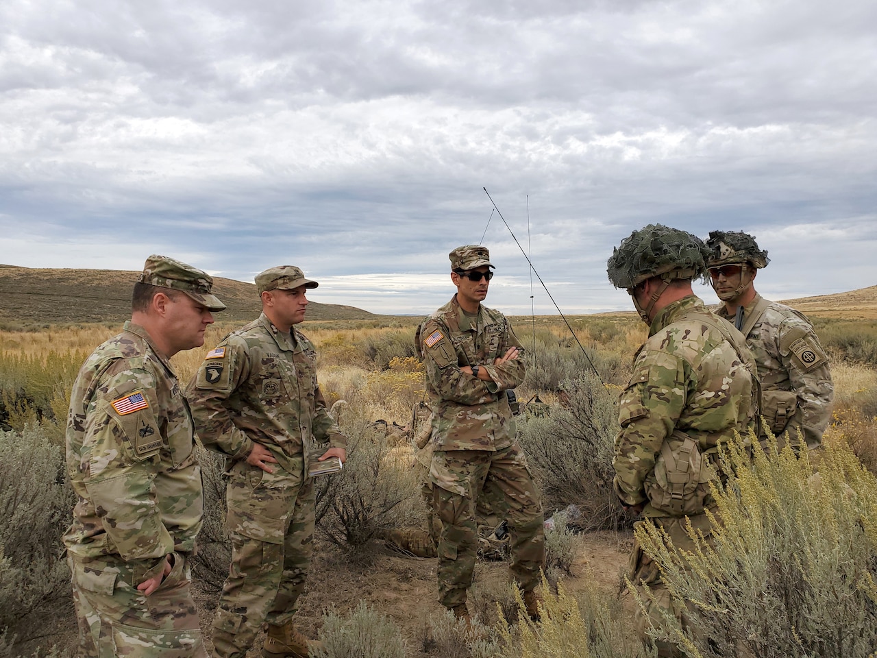 Soldiers stand in group in desert