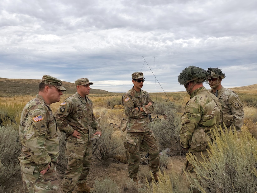 Soldiers stand in group in desert