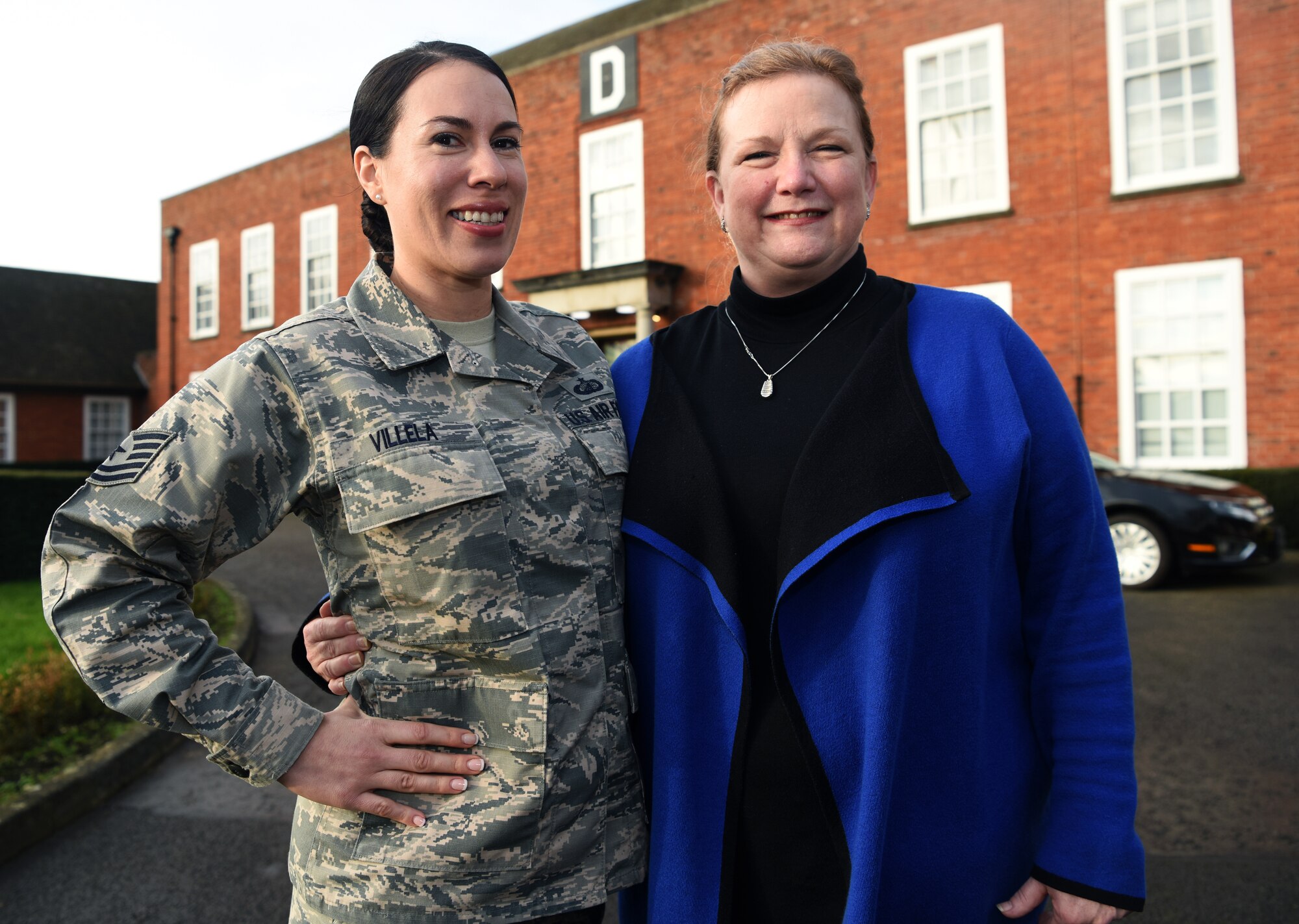 U.S. Air Force Technical Sgt. Genevieve Villela, 100th Air Refueling Wing NCO-in-charge of protocol, and Rebekah Hedstrom, 100th ARW Chief of Protocol, pose for a photo at RAF Mildenhall, England, Jan. 16, 2020. The Protocol Office is in charge of ensuring every visit and ceremony on RAF Mildenhall goes to plan according to Air Force standards. (U.S. Air Force photo by Senior Airman Brandon Esau)