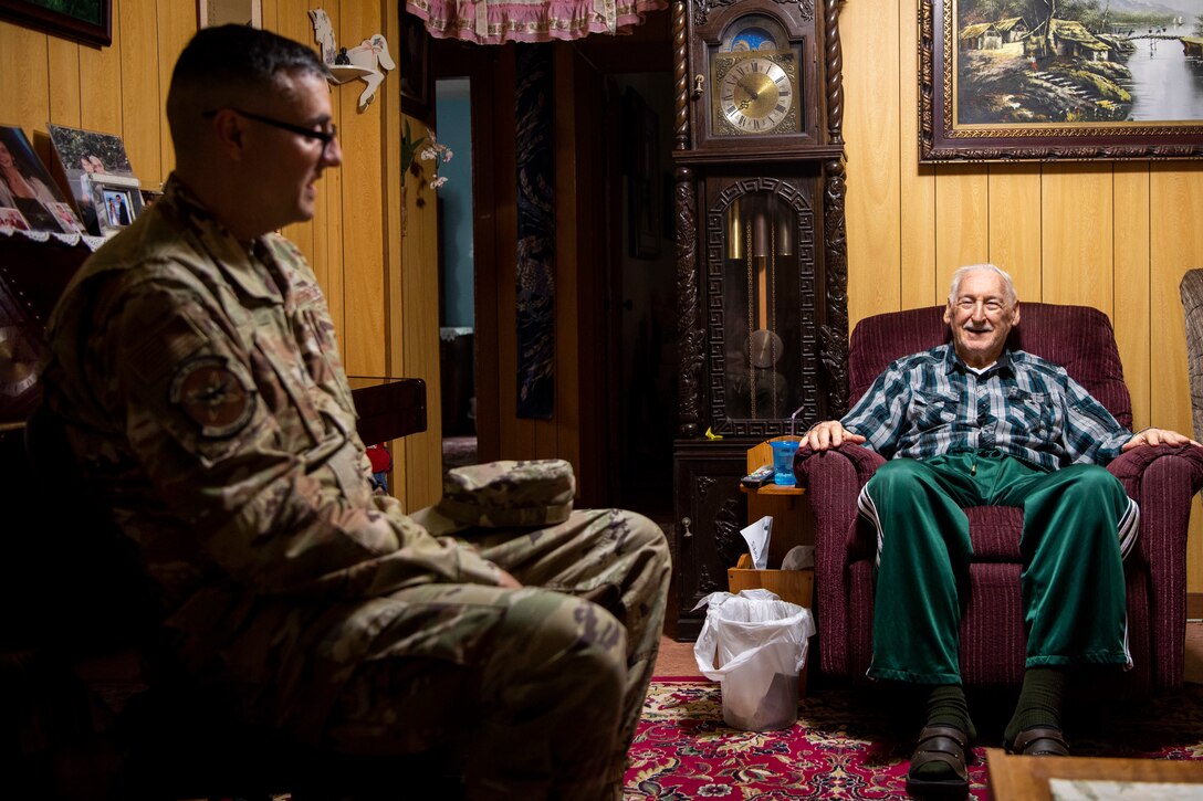 Retired U.S. Air Force Staff Sergeant Dennis Provencher, airborne and ground radio operator, right, receives a memento from Lt. Col. Daniel Waid, 18th Communications Squadron commander, left, for his years of dedicated service on Dec. 23, 2019, in Okinawa City, Okinawa. Provencher served 20 years in the military and continued to serve after retirement in his community and donating blood every two months. (U.S. Air Force Photo by Airman 1st Class Rebeckah Medeiros)