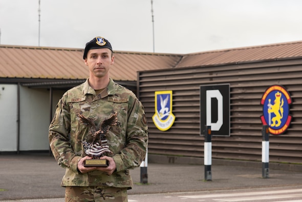Senior Airman Christopher Francis, 100th Security Forces Squadron information assurance officer, poses for a photo with his squadron Airman of the Year award in front of the 100th SFS Jan. 15, 2020, at RAF Mildenhall, England. Francis overcame numerous challenges and an unexpected career change on his way to winning the Airman of the Year award. (U.S. Air Force photo by Airman 1st Class Joseph Barron)