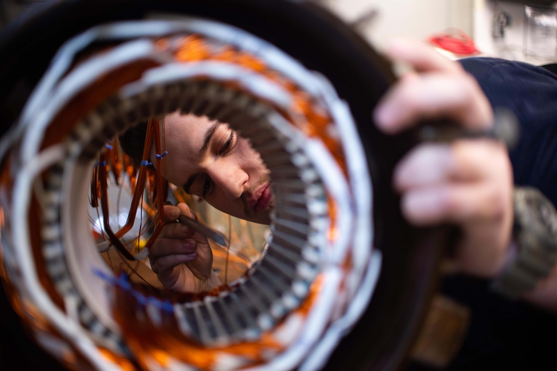 A sailor looks at a circular coil.