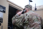 Command Sgt. Major Christopher Kepner, senior enlisted advisor to the chief, National Guard Bureau, helps a soldier check communication equipment before the start of a Command Post Exercise at Camp Murray, Wash., Jan. 10, 2020.