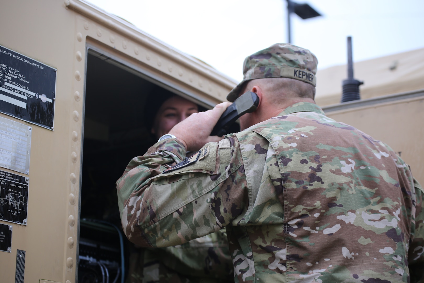 Command Sgt. Major Christopher Kepner, senior enlisted advisor to the chief, National Guard Bureau, helps a soldier check communication equipment before the start of a Command Post Exercise at Camp Murray, Wash., Jan. 10, 2020.