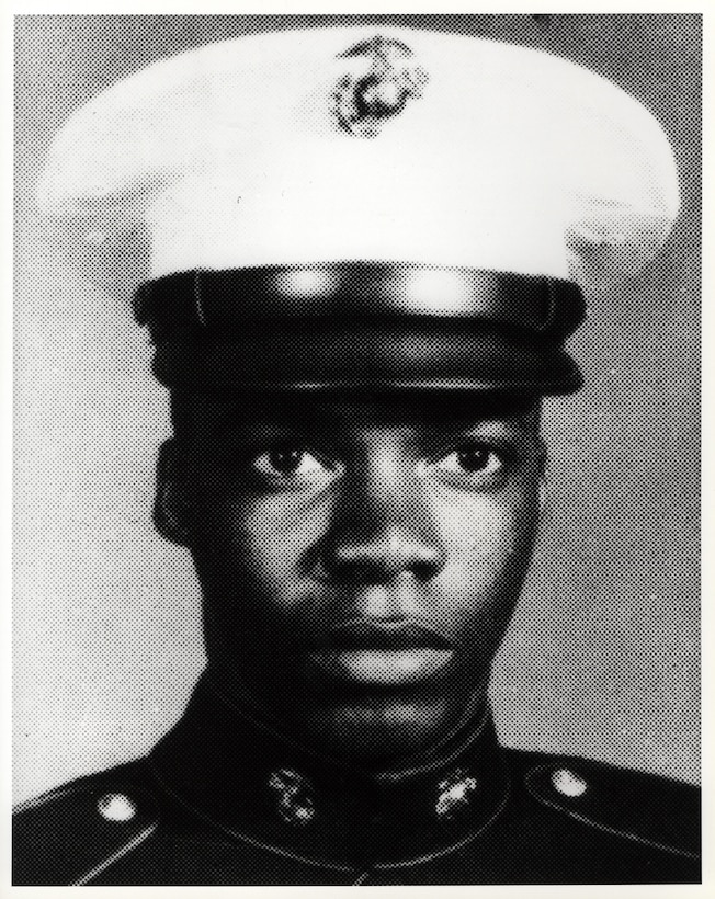 A young Marine wearing a dress cap.