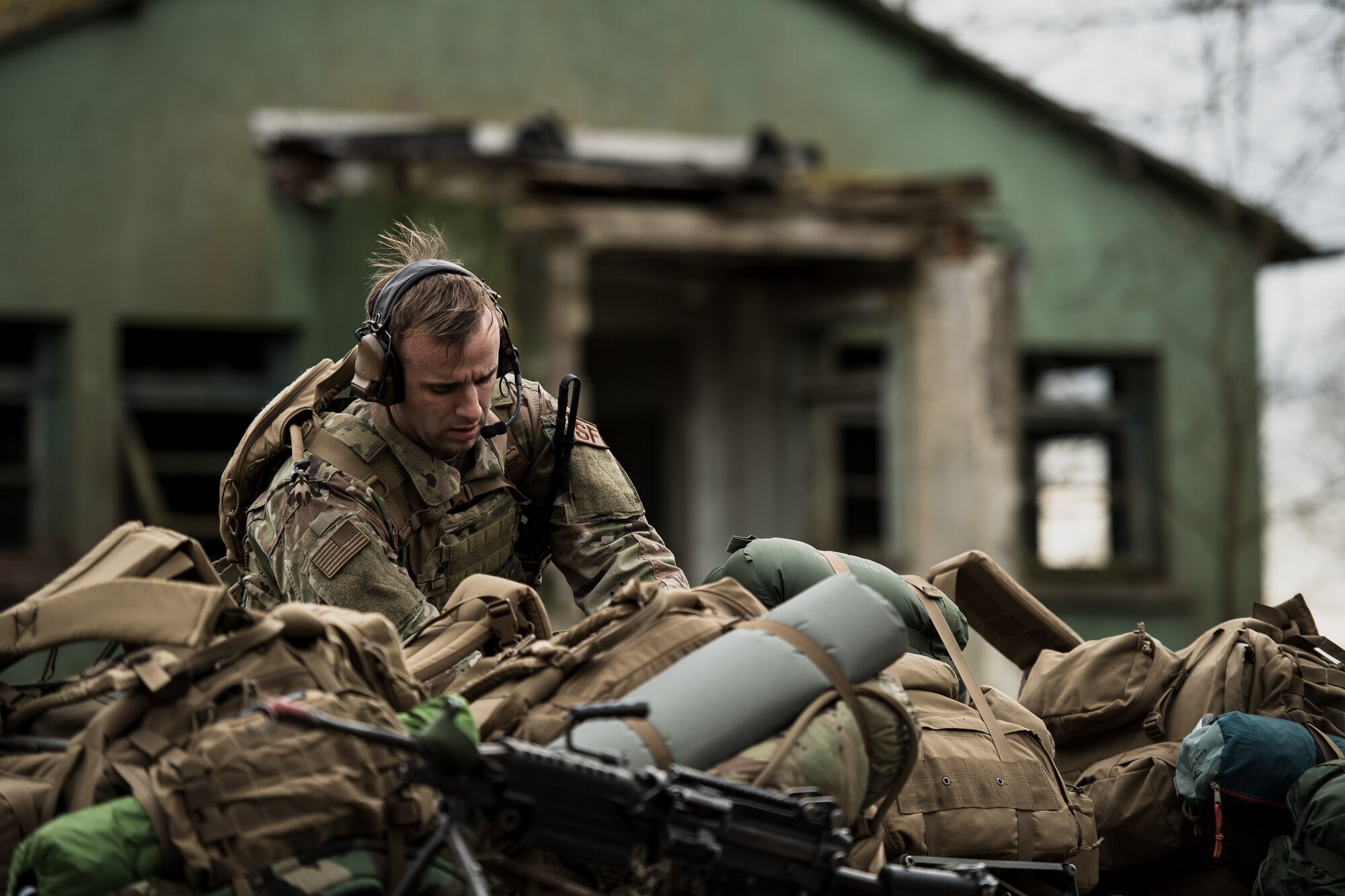 U.S. Air Force Staff Sgt. Anthony Salvione, 435th Security Forces Squadron ground combat readiness training center instructor, sorts through supplies before exercise Frozen Defender in Grostenquin, France, Jan. 14, 2020. Frozen Defender tests the squadron’s capabilities in a contested environment under harsh conditions. The 435th SFS Defenders came prepared with cold-weather gear to combat the lower temperatures which allowed them to train longer, and perform night operations. (U.S. Air Force photo by Staff Sgt. Devin Boyer)