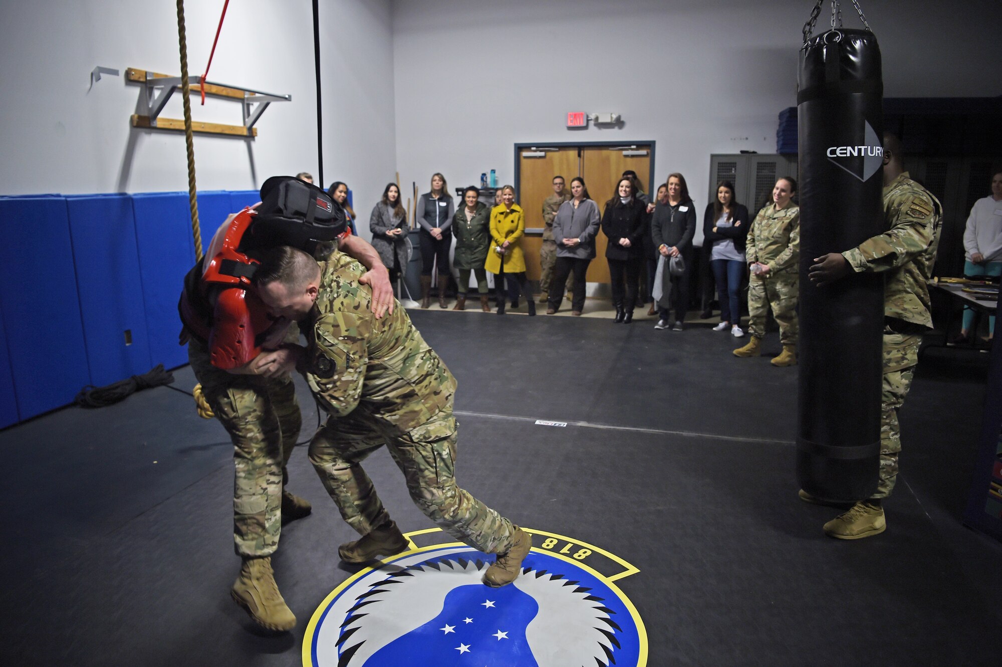 Spouses of 621st Contingency Response Wing Airmen watch a martial arts demonstration at Joint Base McGuire-Dix-Lakehurst, New Jersey, Jan. 16. The spouses spent the afternoon being briefed by senior leadership and reviewing equipment used by personnel out in the field during the Spouse Immersion.