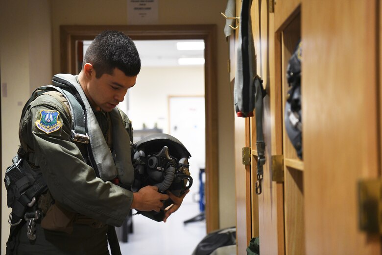 Civil Air Patrol Cadet Colonel Zane Fockler, Mildenhall Cadet Squadron cadet, retrieves his helmet from a locker in the Aircraft Flight Equipment office before his familiarization flight at Royal Air Force Lakenheath, England, January 10, 2019. Fockler was awarded a familiarization flight to recognize his successes and prepare him for his dream to be a pilot in the U.S. Air Force. (U.S.Air Force photo by Senior Airman Shanice Williams-Jones)