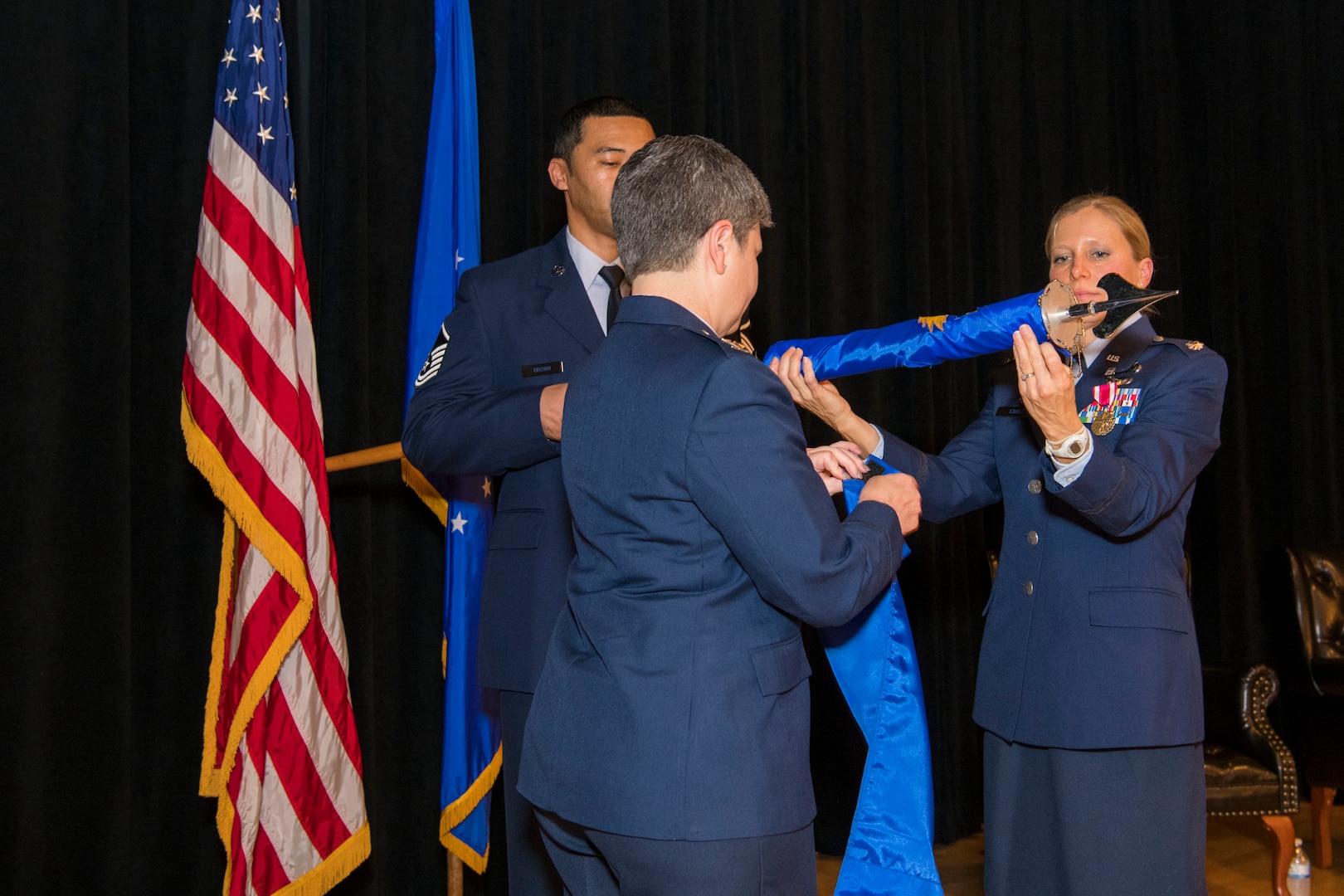 Col. Heidi A. Paulson, Air Force Manpower Analysis Agency commander, Lt. Col. Jessica Corea, 1st Manpower Requirements Squadron commander, and Master Sgt. Waymon Brown, Jr., 1st MRS NCO in charge of A-branch, furl the unit flag during the inactivation ceremony Jan. 9, 2020, at Joint Base San Antonio-Randolph, Texas. It is military custom to furl and encase the flag upon the completion of the organization’s mission.