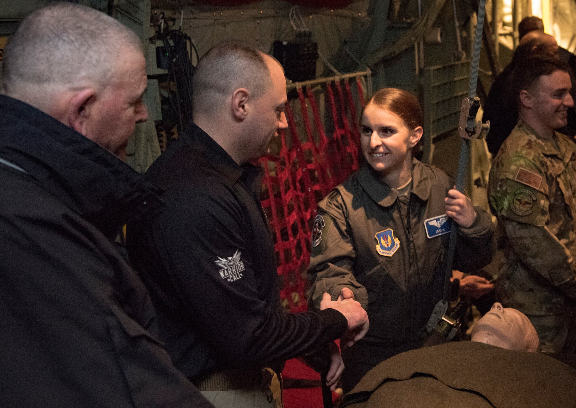 Retired U.S. Marine Corps Cpl. Matt Bradford, middle, a wounded warrior, meets U.S. Air Force Capt. Joanna Guhl, 86th Aeromedical Evacuation Squadron flight nurse, at Ramstein Air Base, Germany, Jan. 13, 2020. The OPE mission provides combat-wounded warriors the opportunity to gain closure as part of their recovery, while providing service members the opportunity to meet and learn from the veterans. Members of the 86th AES and 86th Aircraft Maintenance Squadron gave the wounded warriors a guided tour of a C-130J Super Hercules aircraft, like the ones used to medically evacuate the veterans years ago.