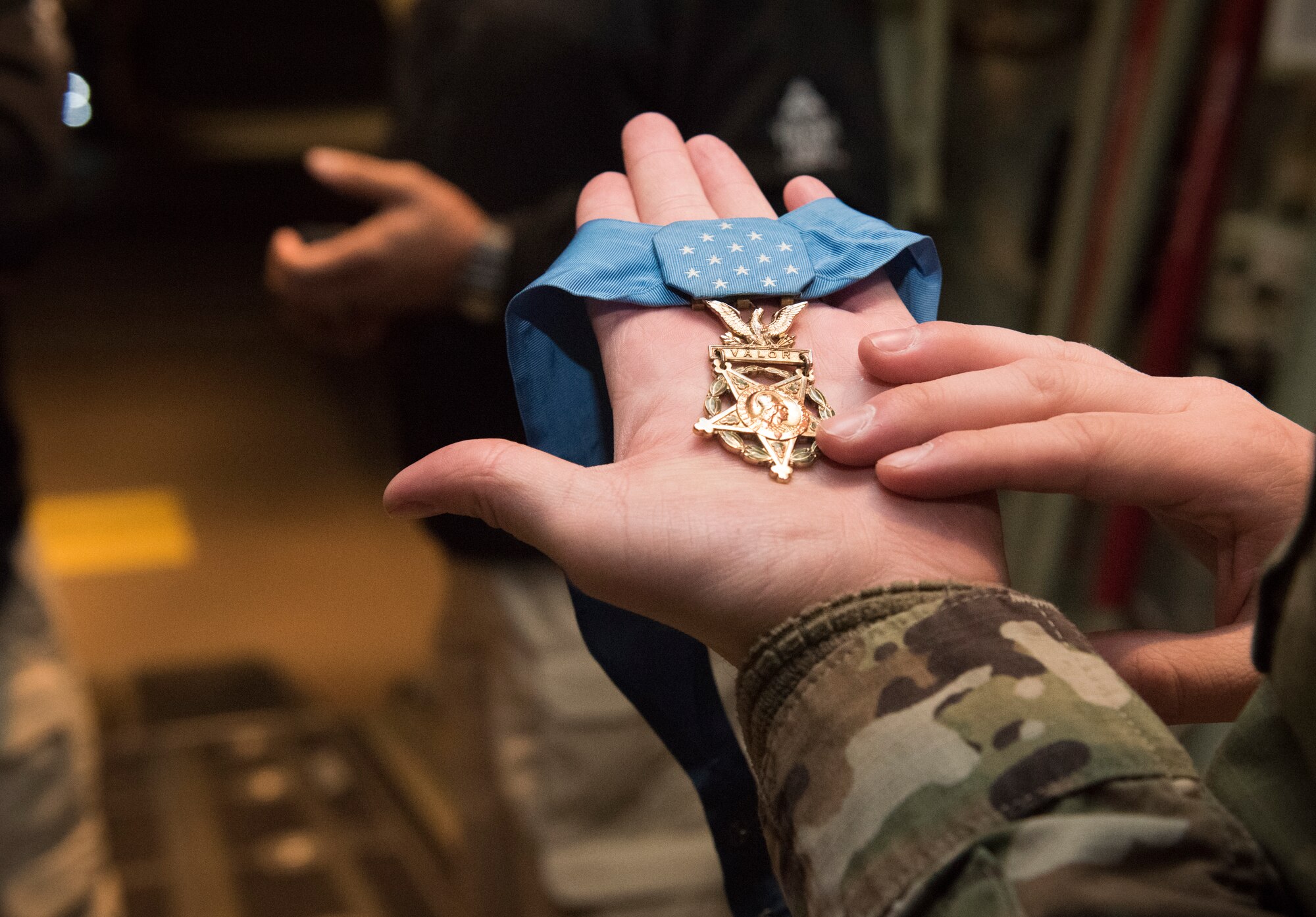 U.S. Air Force Senior Airman Terry Kularski, 86th Aircraft Maintenance Squadron hydraulic system specialist, holds a medal of honor awarded to retired U.S. Army Master Segt. Leroy Petry, wounded warrior, at Ramstein Air Base, Germany, Jan. 13, 2020. While assigned to the 75th Ranger Regiment, Petry suffered combat wounds, including a gunshot to his thighs and an enemy grenade explosion in-hand. Petry is currently working as a military liaison for Troops First Foundation, is vice president of the Medal of Honor Society, and an ambassador for the president of the United States executive order for suicide prevention.