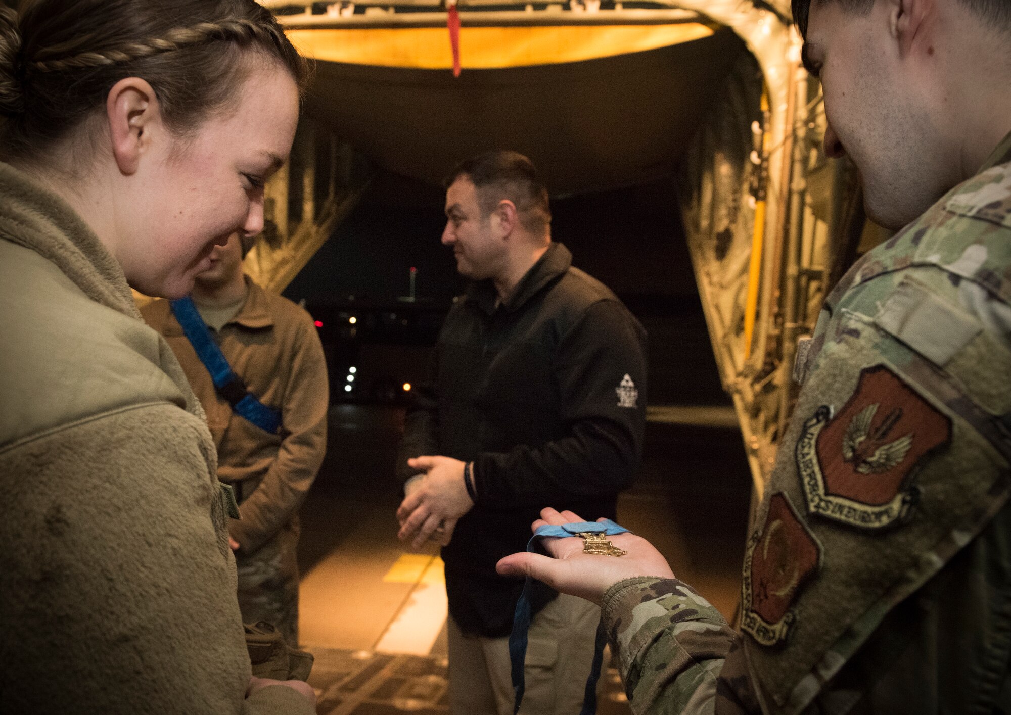 U.S. Air Force 2nd Lt. Lydia Byrom, left, 86th Aeromedical Evacuation Squadron readiness officer in charge, and Senior Airman Terry Kularski, 86th Aircraft Maintenance Squadron hydraulic system specialist, look at a medal of honor at Ramstein Air Base, Germany, Jan. 13, 2020. The medal was awarded to retired U.S. Army Master Segt. Leroy Petry for his actions in Afghanistan in 2008. Operation Proper Exit and the Troops First Foundation brought Petry and several other wounded warriors to Ramstein to visit the 86th AES, the squadron that medically evacuated them from Iraq and Afghanistan to Landstuhl Regional Medical Center.