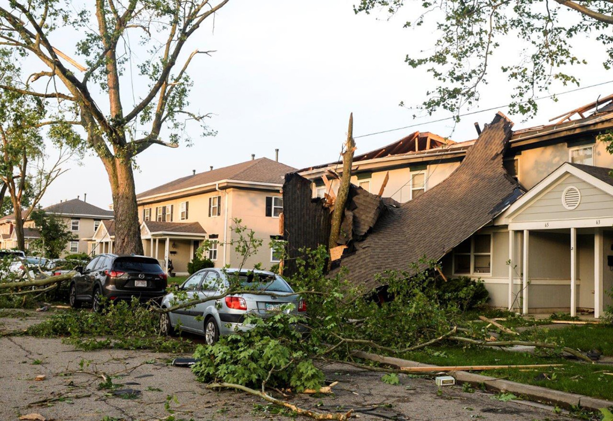 What remains of a roof dangles in front of a home after being taken off by a tornado that damaged approximately 150 homes May 27 in the Properties of Wright-Field at Wright-Patterson Air Force Base. Volunteers from around Wright-Patterson AFB worked alongside base emergency responders and housing residents to ensure everyone’s safety and begin the cleanup process. (U.S. Air Force photo/Wesley Farnsworth