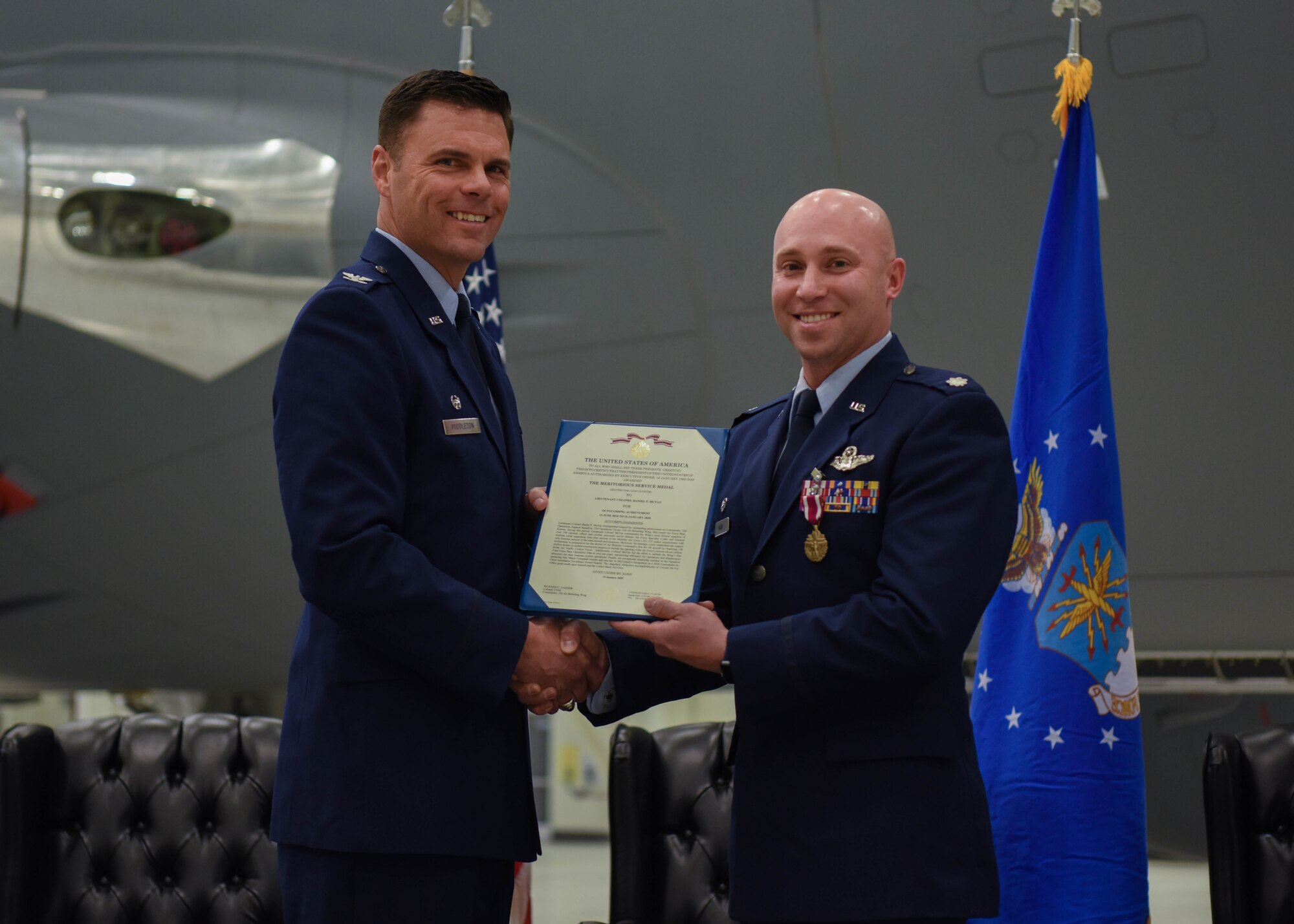 Col. Thad Middleton, 22nd Operations Group commander, presents the Meritorious Service Medal citation to Lt. Col. Daniel McVay, the outgoing 22nd Operations Support Squadron commander, during a change of command ceremony Jan. 16, 2020, at McConnell Air Force Base, Kansas. The Meritorious Service Medal is awarded to members of the U.S. Armed Forces who distinguished themselves by outstanding noncombat meritorious achievement or service. (U.S. Air Force photo by Airman 1st Class Marc A. Garcia)