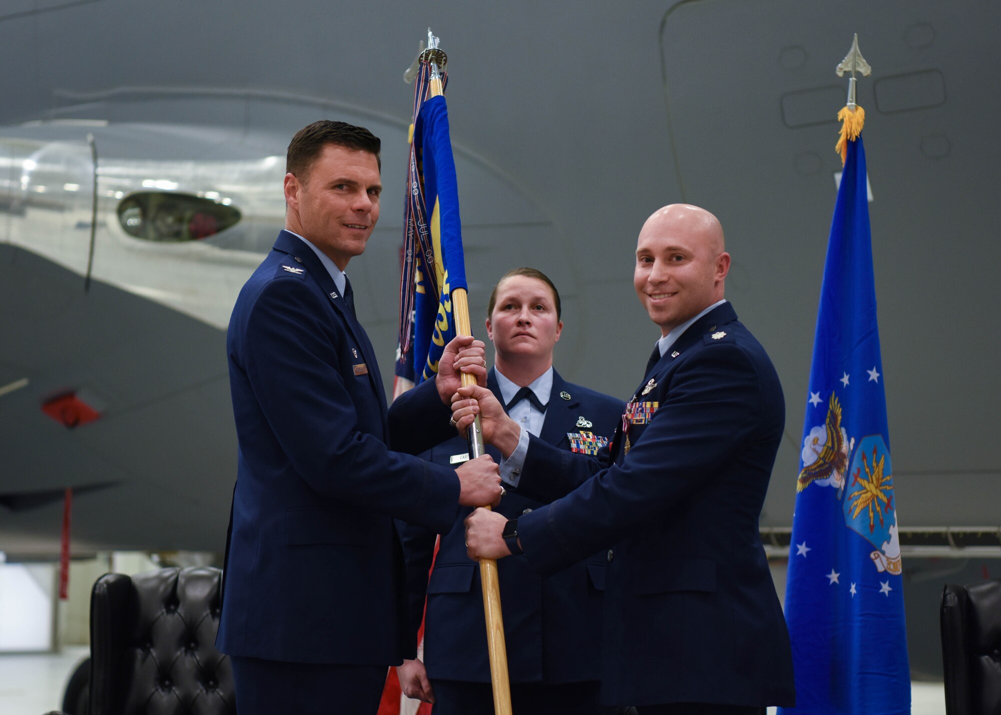 Lt. Col. Daniel McVay, the outgoing 22nd Operations Support Squadron commander, passes the 22nd OSS guidon to Col. Thad Middleton, 22nd Operations Group commander, during a change of command ceremony Jan. 16, 2020, at McConnell Air Force Base, Kansas. McVay served as the 22nd OSS commander for two years before relinquishing command. (U.S. Air Force photo by Airman 1st Class Marc A. Garcia)