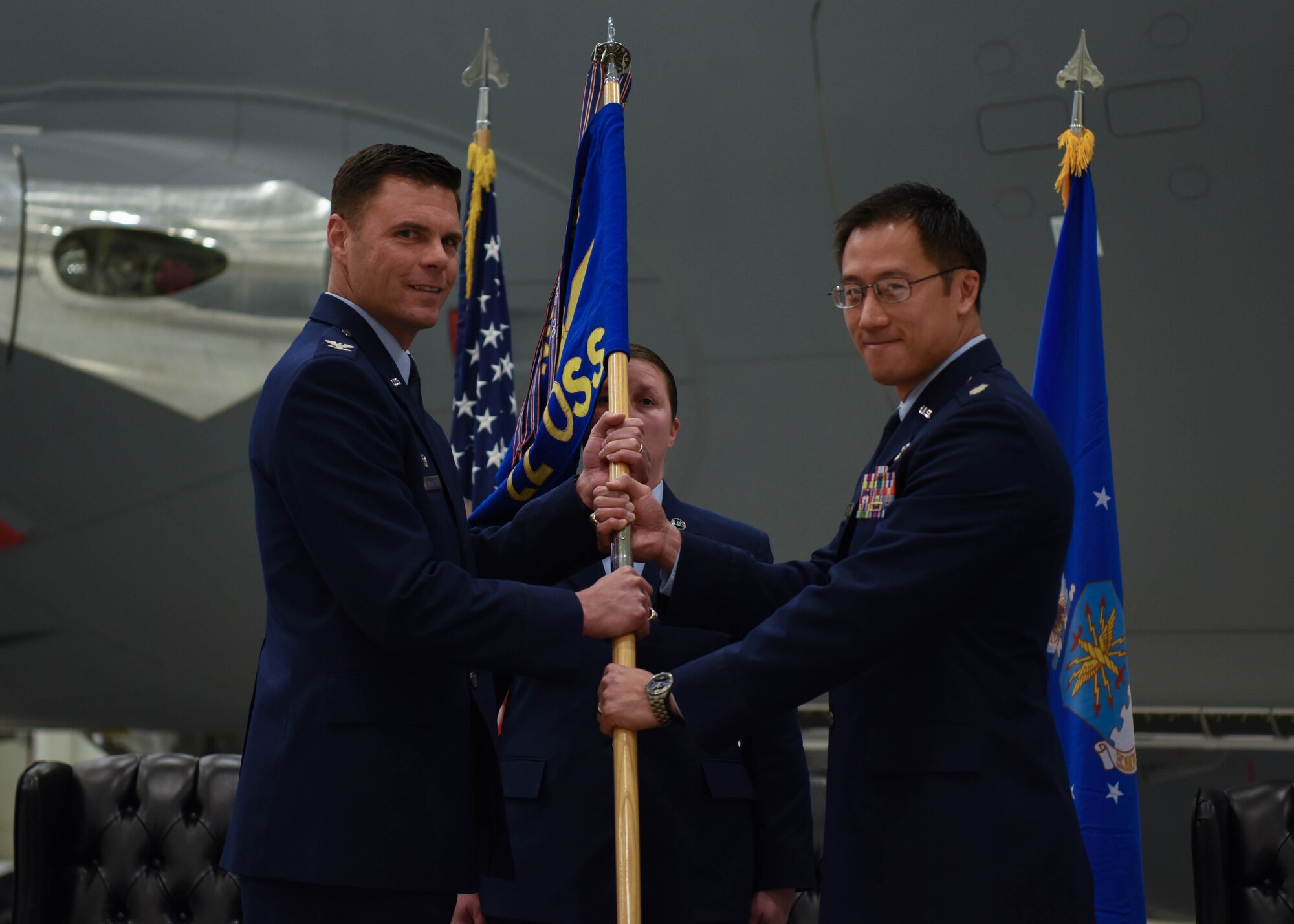 Col. Thad Middleton, 22nd Operations Group commander, passes the 22nd Operations Support Squadron guidon to Lt. Col. Kenneth Louie, the incoming 22nd OSS commander, during a change of command ceremony Jan. 16, 2020, at McConnell Air Force Base, Kansas. Louie accepted the reins of responsibility, authority and accountability when after accepting the 22nd OSS guidon from Middleton. (U.S. Air Force photo by Airman 1st Class Marc A. Garcia)