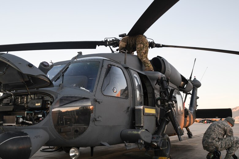 U.S. Air Force Airmen assigned to the 55th Rescue Squadron work on a HH-60G Pave Hawk on the flight line at Davis-Monthan Air Force Base, Arizona, Jan. 14, 2020. Airmen are responsible for each piece of mission equipment on the HH-60 to include .50 caliber machine guns and a hoist. (U.S. Air Force photo by Senior Airman Cheyenne A. Powers)
