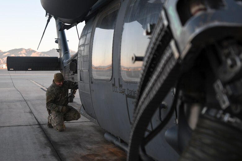 A U.S. Air Force Airman assigned to the 55th Rescue Squadron work on a HH-60G Pave Hawk on the flight line at Davis-Monthan Air Force Base, Arizona, Jan. 14, 2020. Airmen are responsible for each piece of mission equipment on the HH-60 to include .50 caliber machine guns and a hoist. (U.S. Air Force photo by Senior Airman Cheyenne A. Powers)