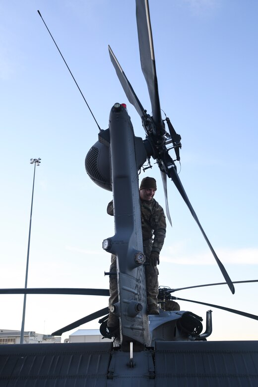 U.S. Air Force Staff Sgt. Steffen Adams, 55th RQS special mission aviator, performs pre-flight inspections on a HH-60G Pave Hawk on the flight line at Davis-Monthan Air Force Base, Arizona, Jan. 14, 2020.